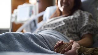 slightly blurred image of a young woman in a hospital bed