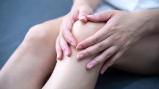 Person holding their knee in apparent pain