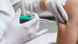 Healthcare professional giving patient a shot in the arm