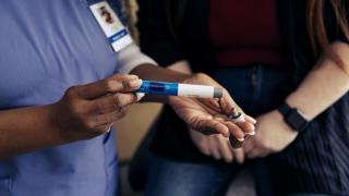 Hospital worker opening an ozempic pen