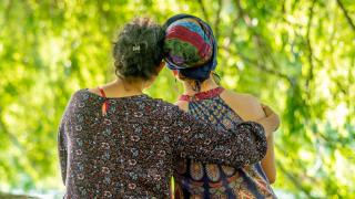 Two female cancer survivors hugging and comforting each other