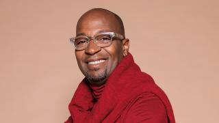 songwriter and vocal producer Kuk Harrell smiling joyfully