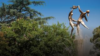 The Spirit of Life fountain on campus depicts two parents lifting a child with joy