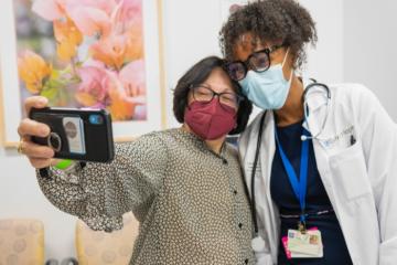 A patient taking a selfie with her doctor