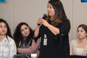 A Women speaking to a criwd