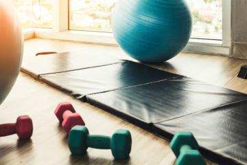 Spacious gymnasium with various fitness equipment neatly arranged.