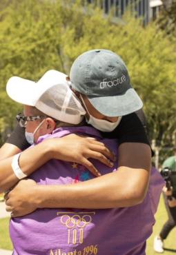 Thevi getting a hug from a friend