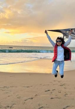 Cary Chang celebrating on the beach