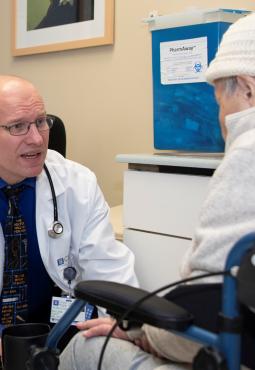 Dr. William Dale providing personalized care to an older adult with cancer