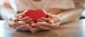 Hands holding red heart